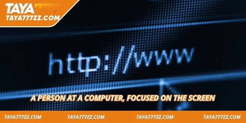A person at a computer, focused on the screen